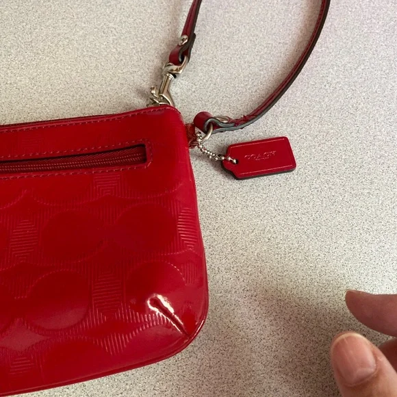 Coach Glossy Embossed Signature Wristlet
Cranberry Patent Leather Red - Picture 13 of 13